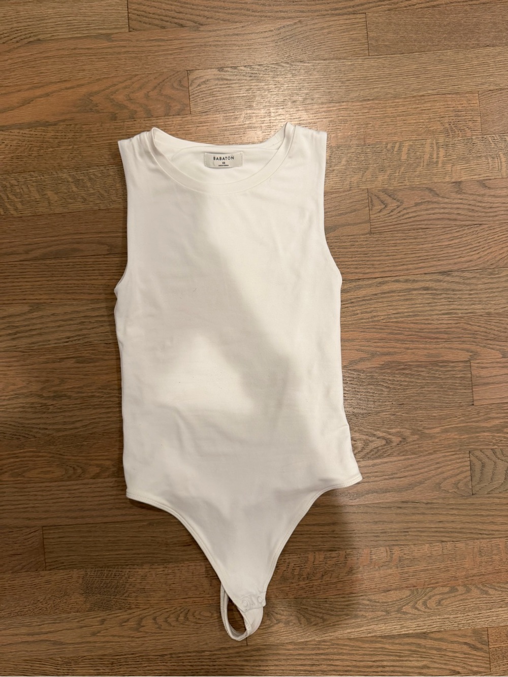 Babaton White Sleeveless Bodysuit with Snap Closure